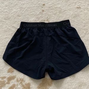 Black Outdoor Voices athletic shorts.